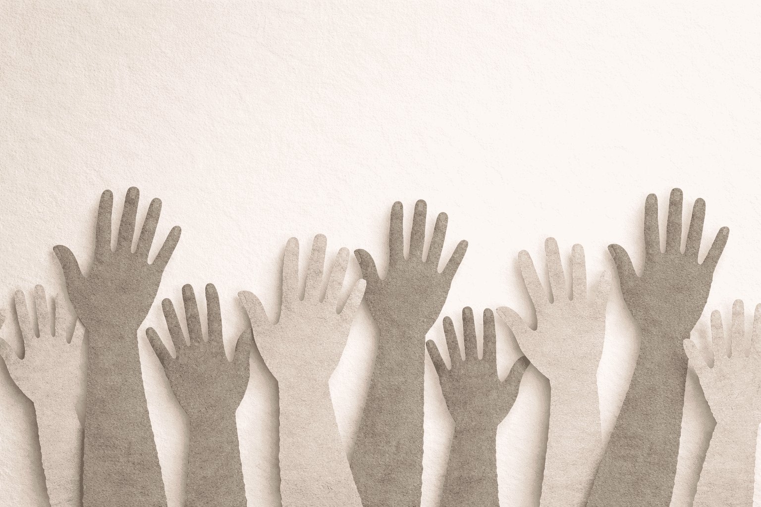 Row of raised cut paper hands on light background